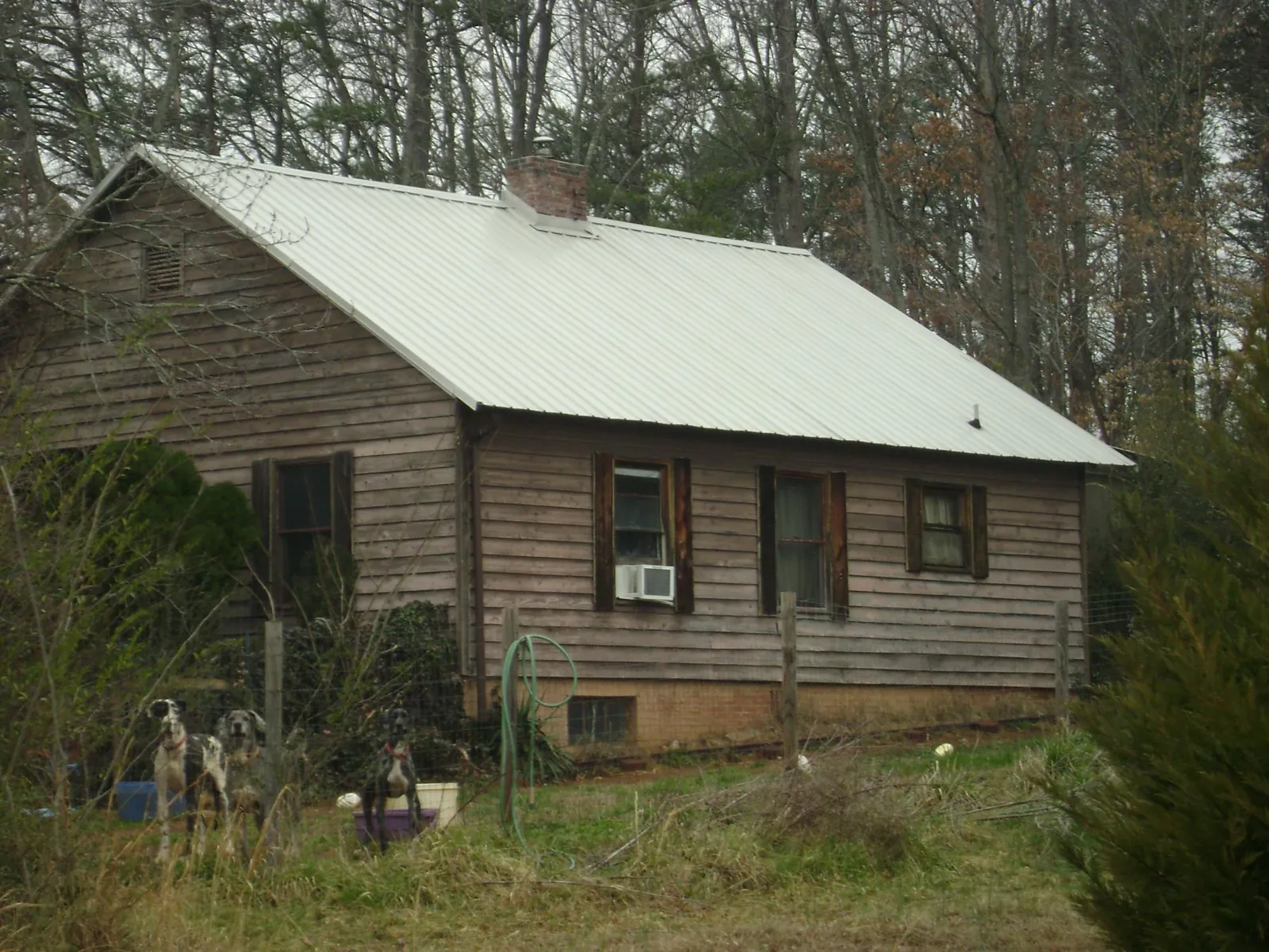 White metal roof on an old wood sided farmhouse, from a Metal Roof Installation job in Annapolis Junction
